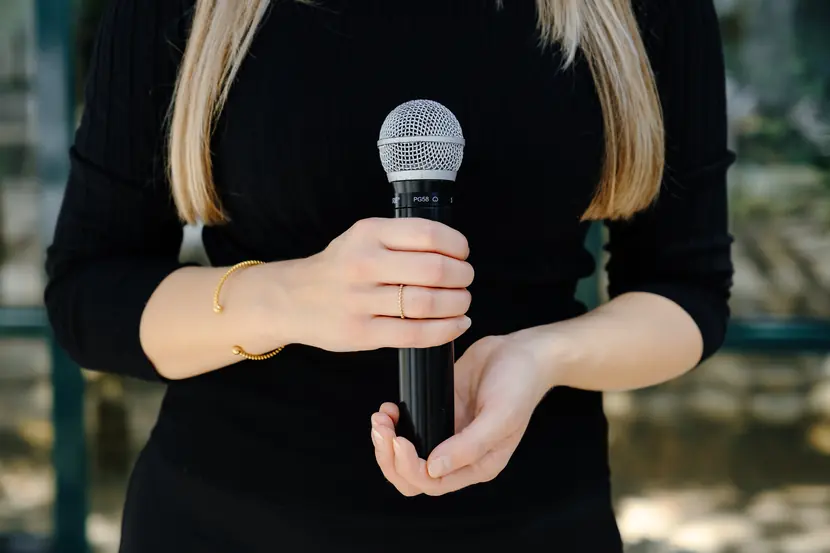 Trauersängerin hält das Mikrofon in der Hand – Musik für Trauerfeier, Beerdigung und Lebensfeier
